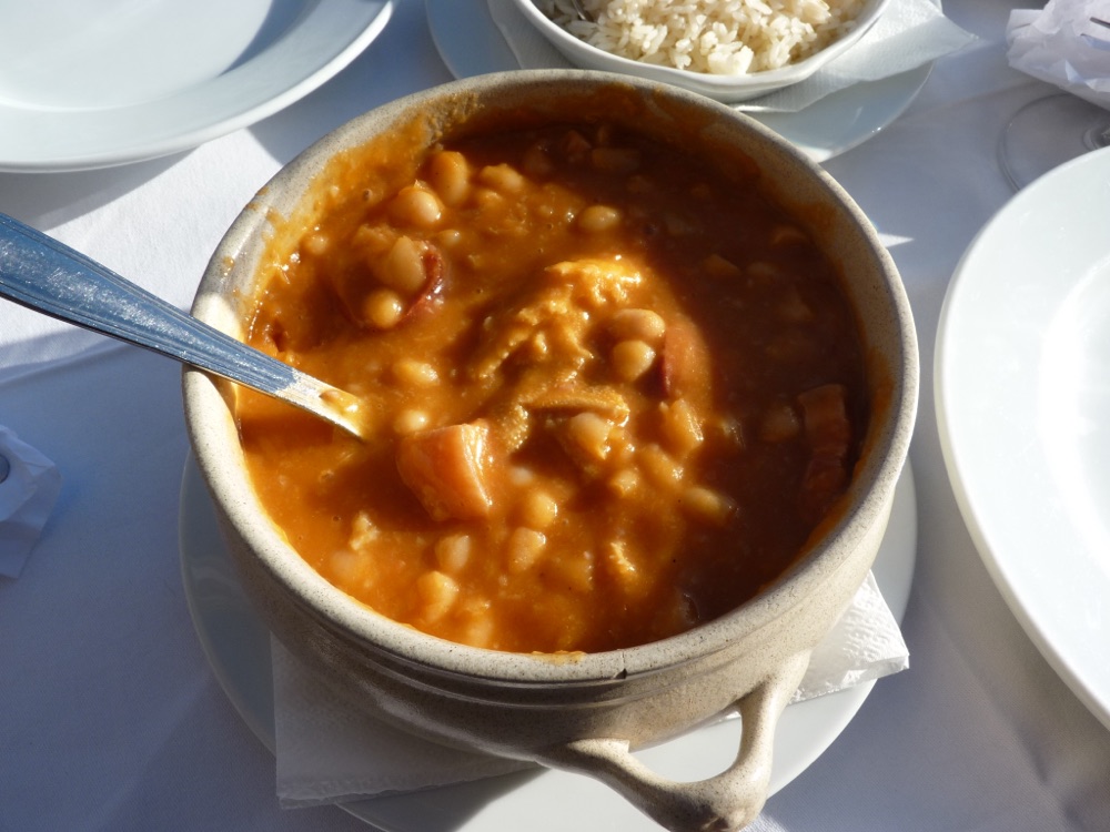 Traditional bowl of Tripas à moda do Porto with white beans